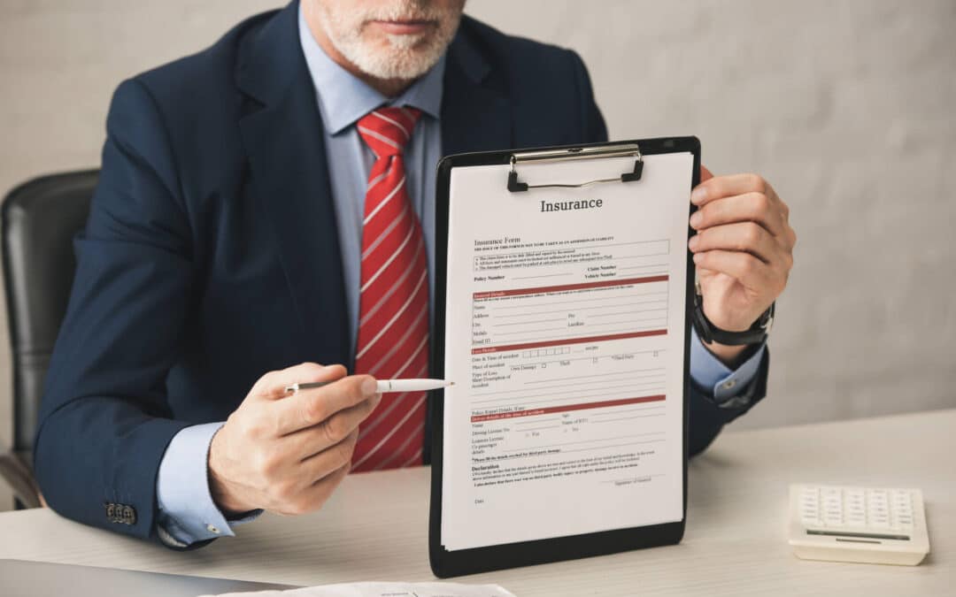 man holding up an insurance document form an insurance business consulting company