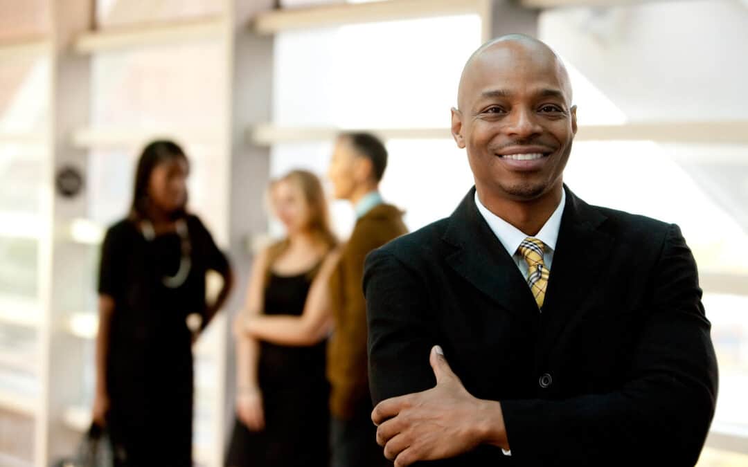 a smiling African-American business man buying an insurance agency business for sale
