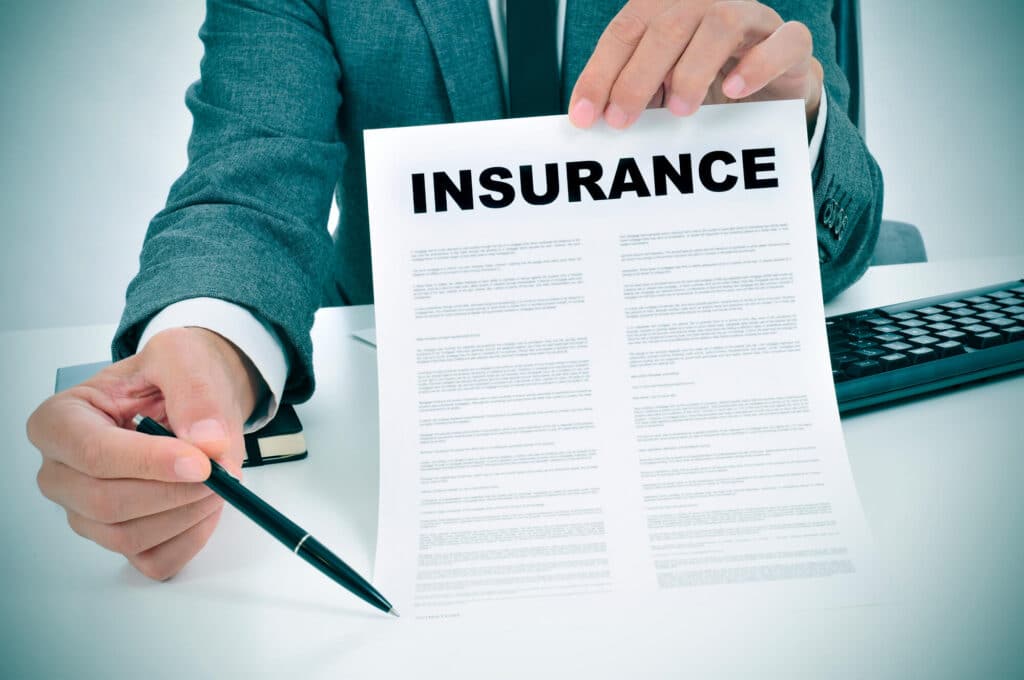 man from an insurance agency consulting holding an insurance form