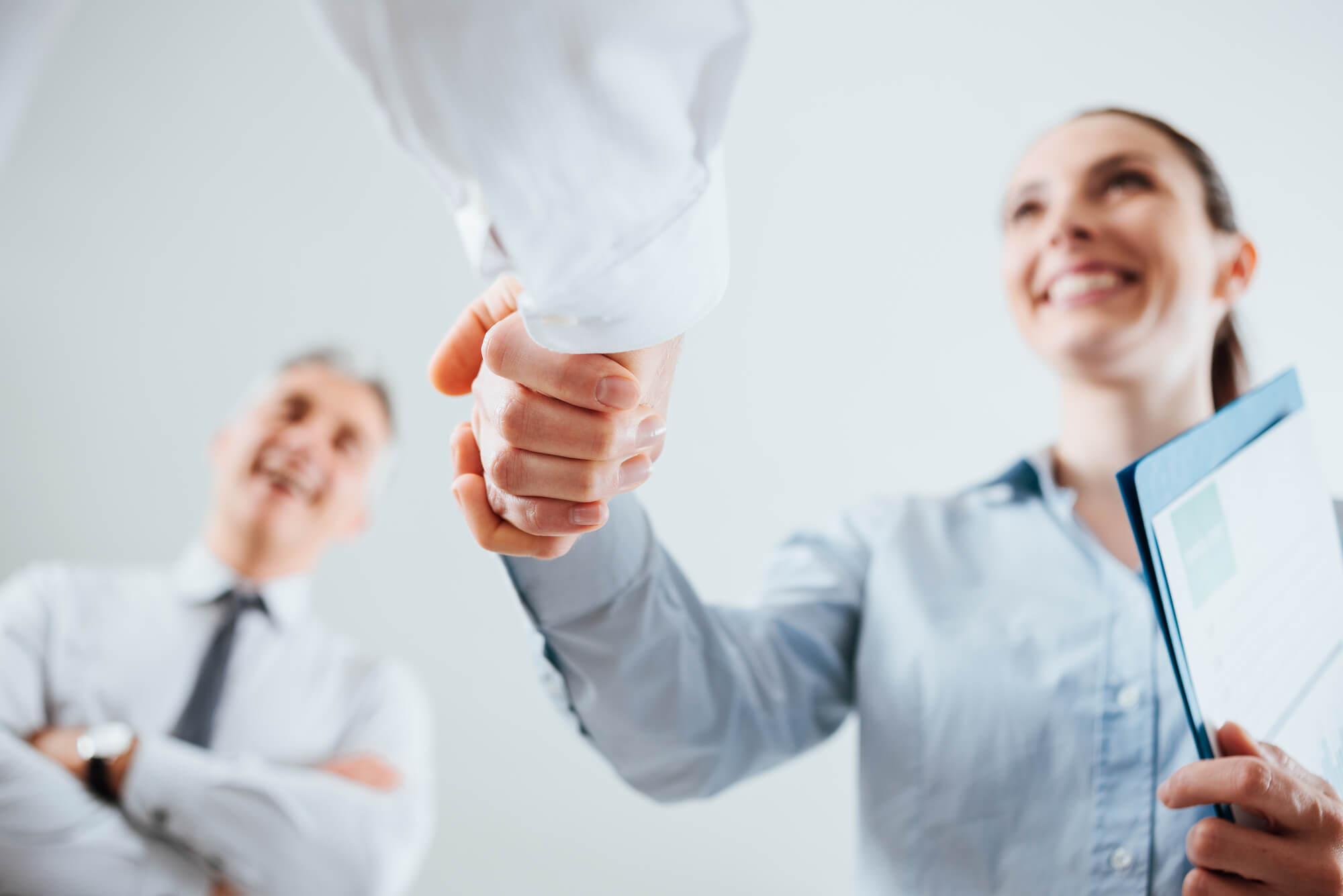 business people shaking hands after purchasing an insurance agency business for sale