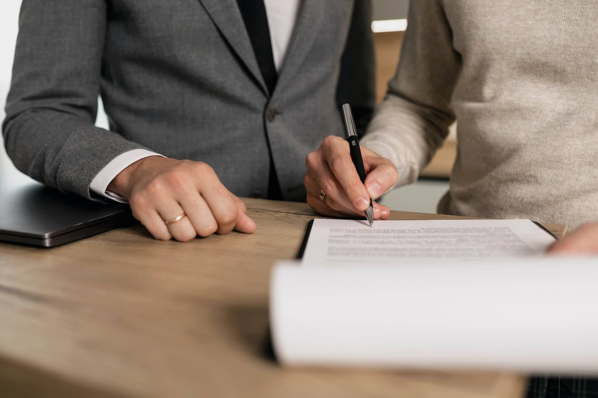 business owner signing documents after buying an insurance agency